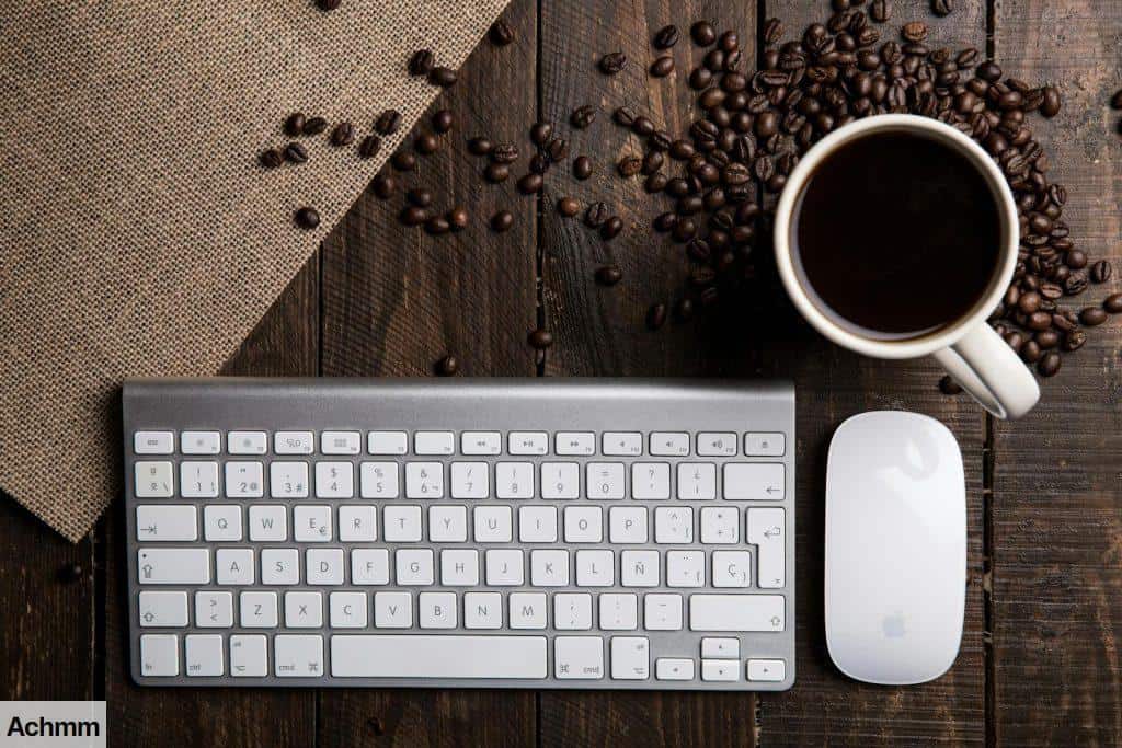 Flat Lay Photography of Apple Magic Keyboard, Mouse, and Mug Filled With Coffee Beside Beans
