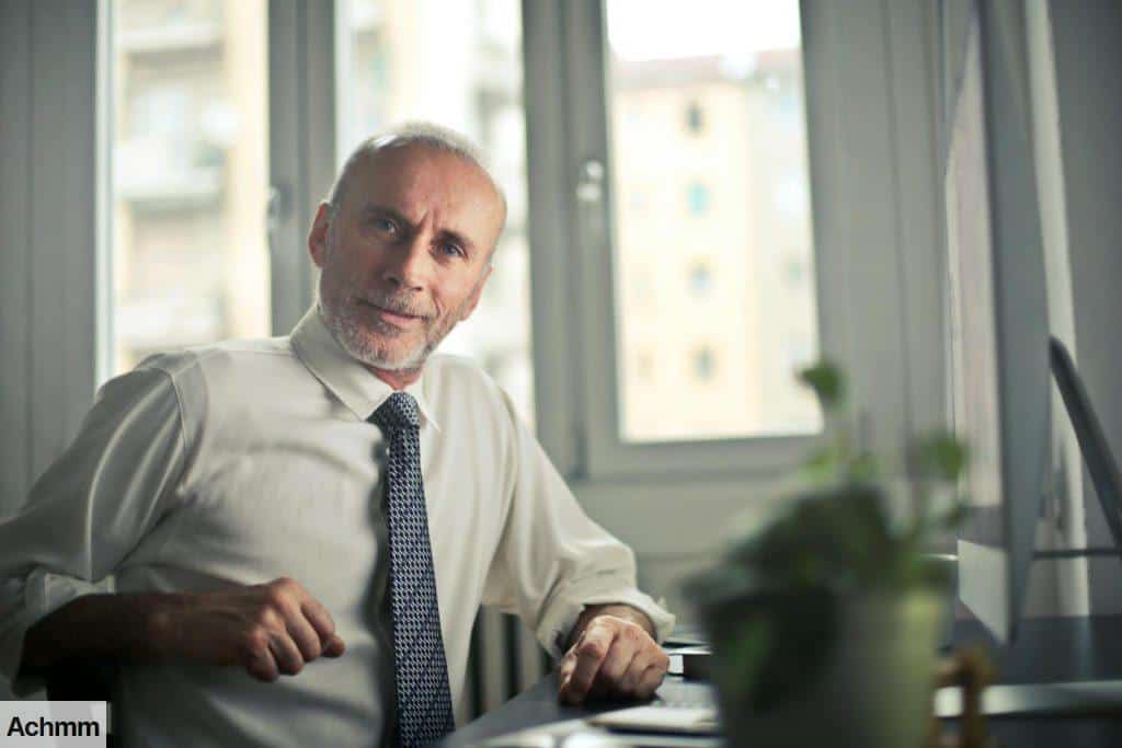 Man Sitting on Chair Beside Table