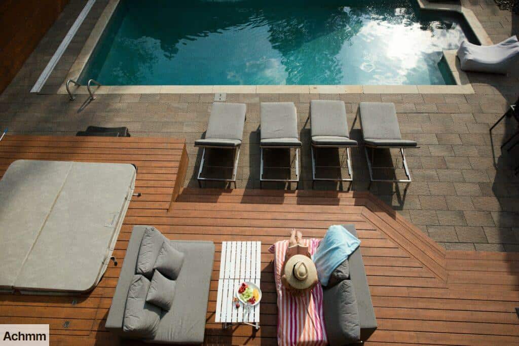 four gray loungers near pool