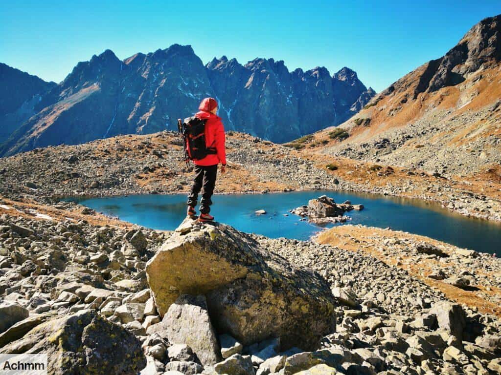 man standing on rock during daytime
